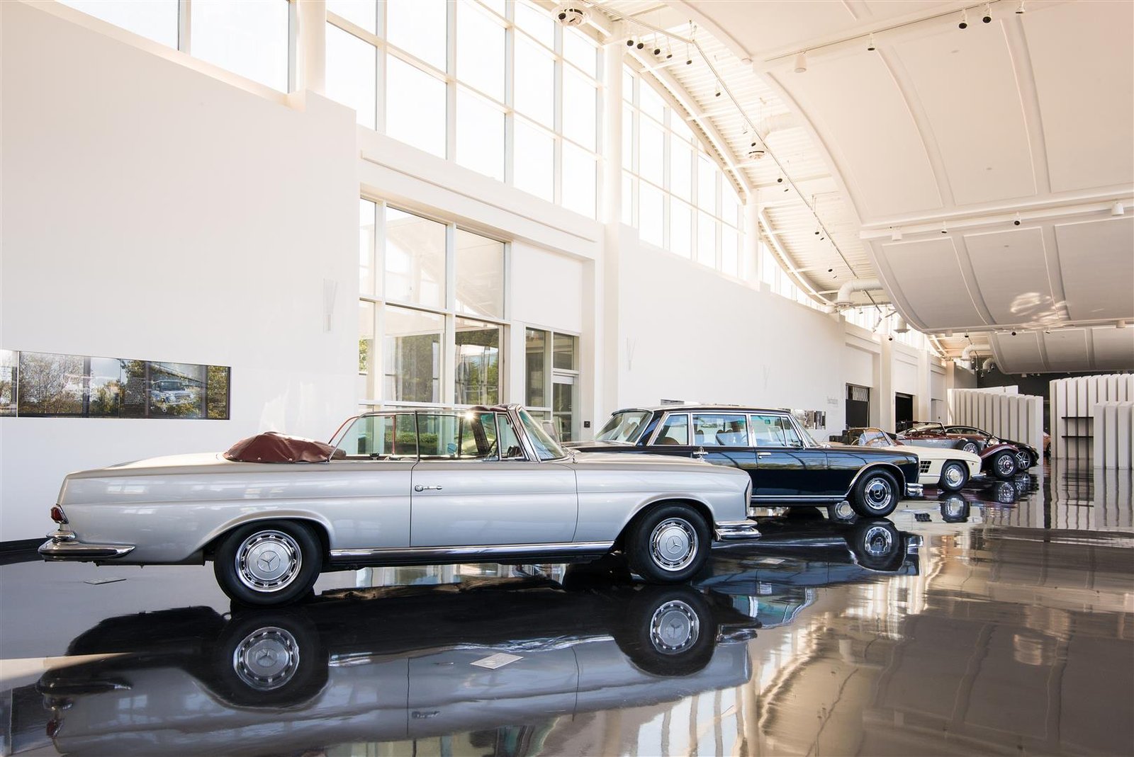 Visitors exploring an automotive museum exhibit